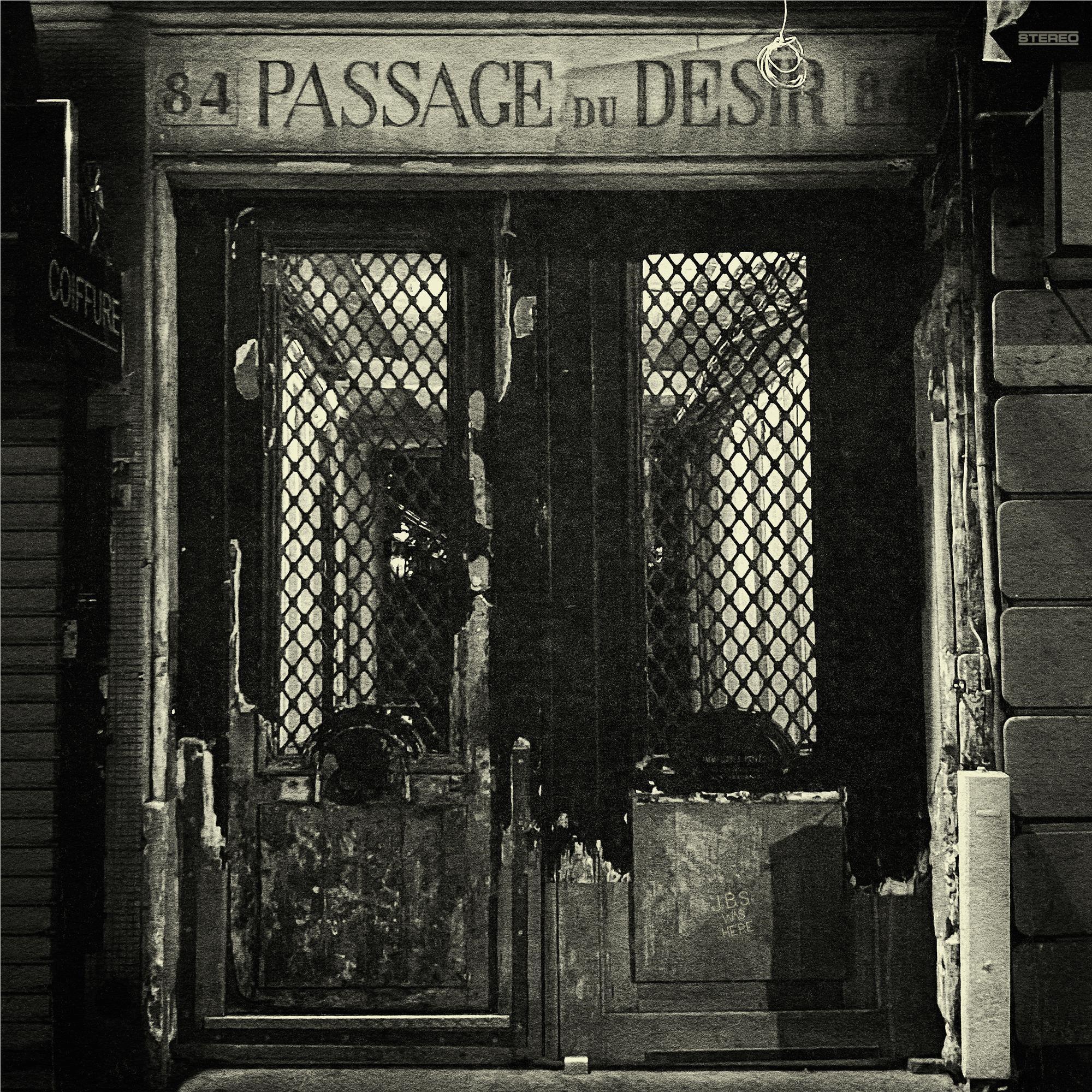 Doorway with “PASSAGE DU DESIR” sign and metal gate with lattice panels