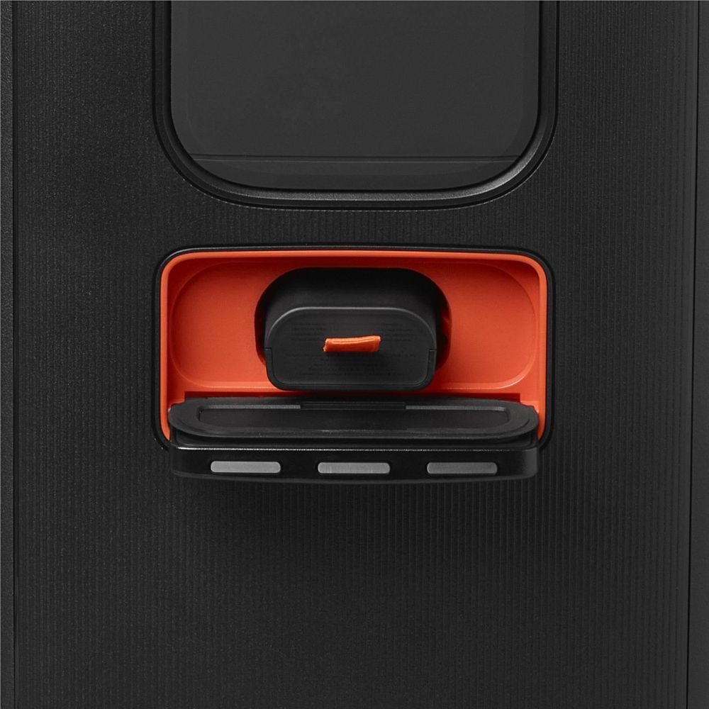 JBL Battery 200 inserted into a speaker battery bay, orange tab visible
