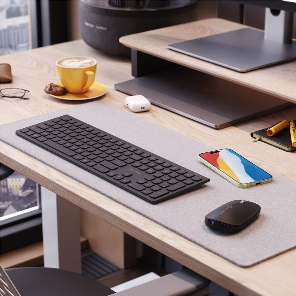 Black wireless keyboard with matching wireless mouse on a desk
