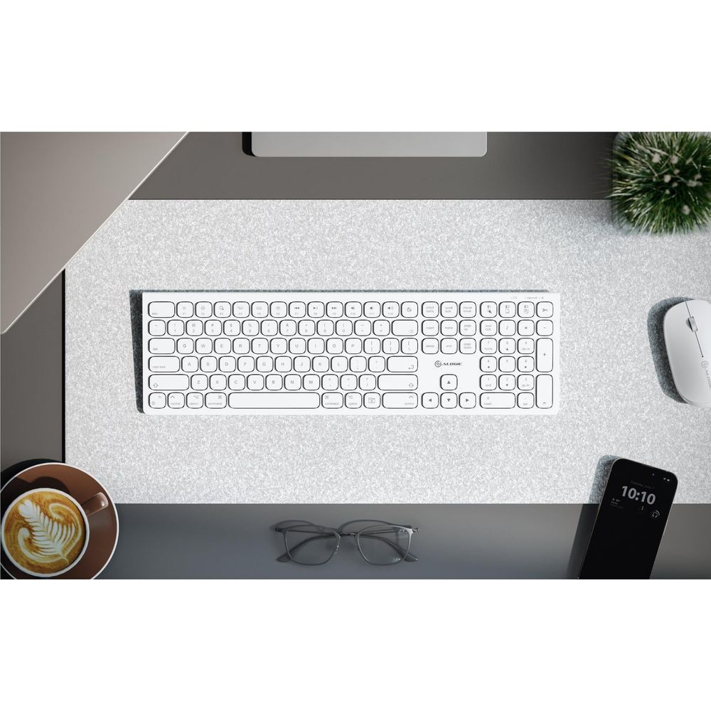 White wireless keyboard on felt desk mat, full key layout visible