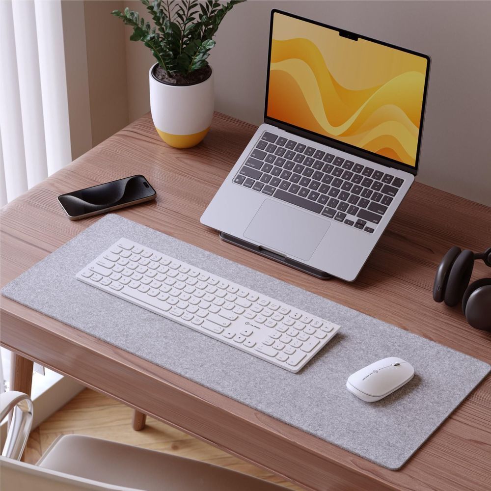 White wireless keyboard on desk, full-size keycaps with sculpted edges
