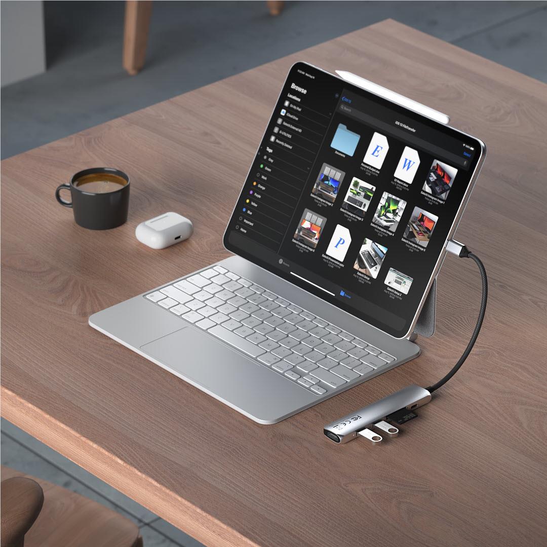 USB-C multiport hub connected to laptop, with cables attached to the hub