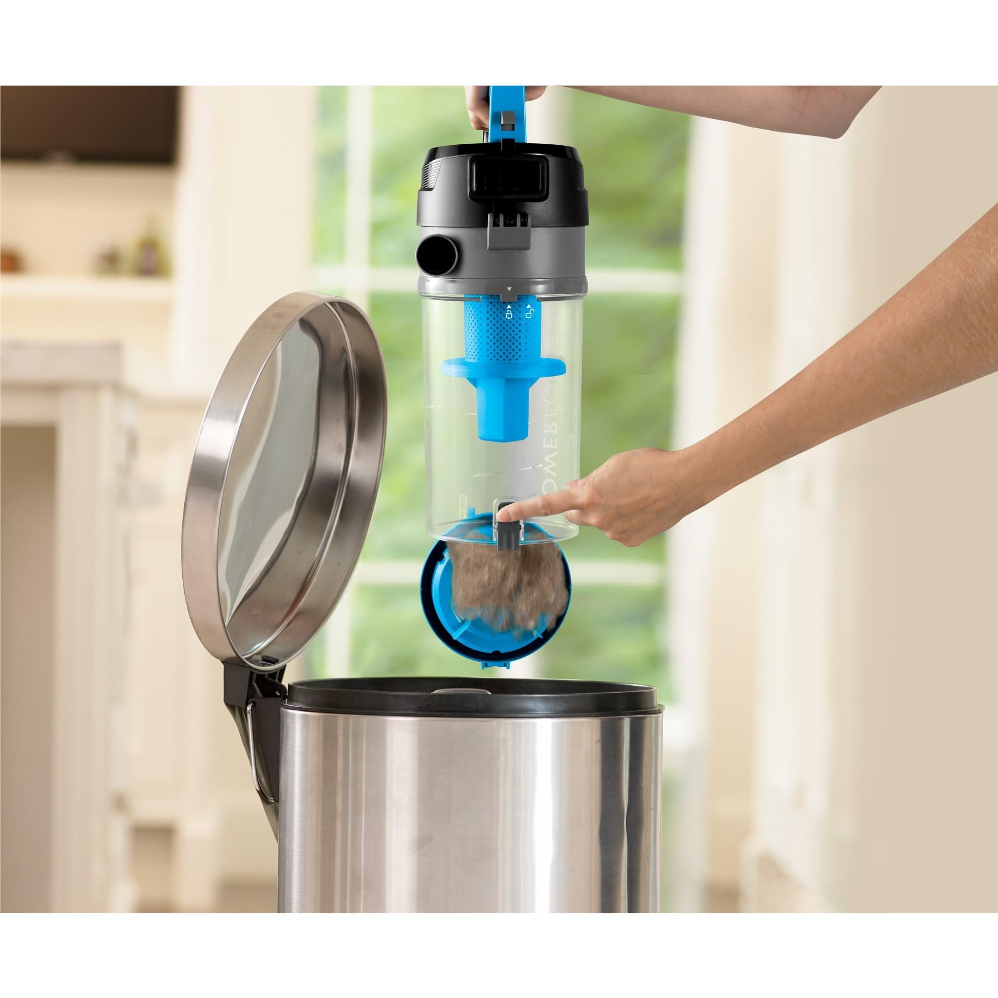 Hand removing dirt bin from bagless vacuum canister for emptying