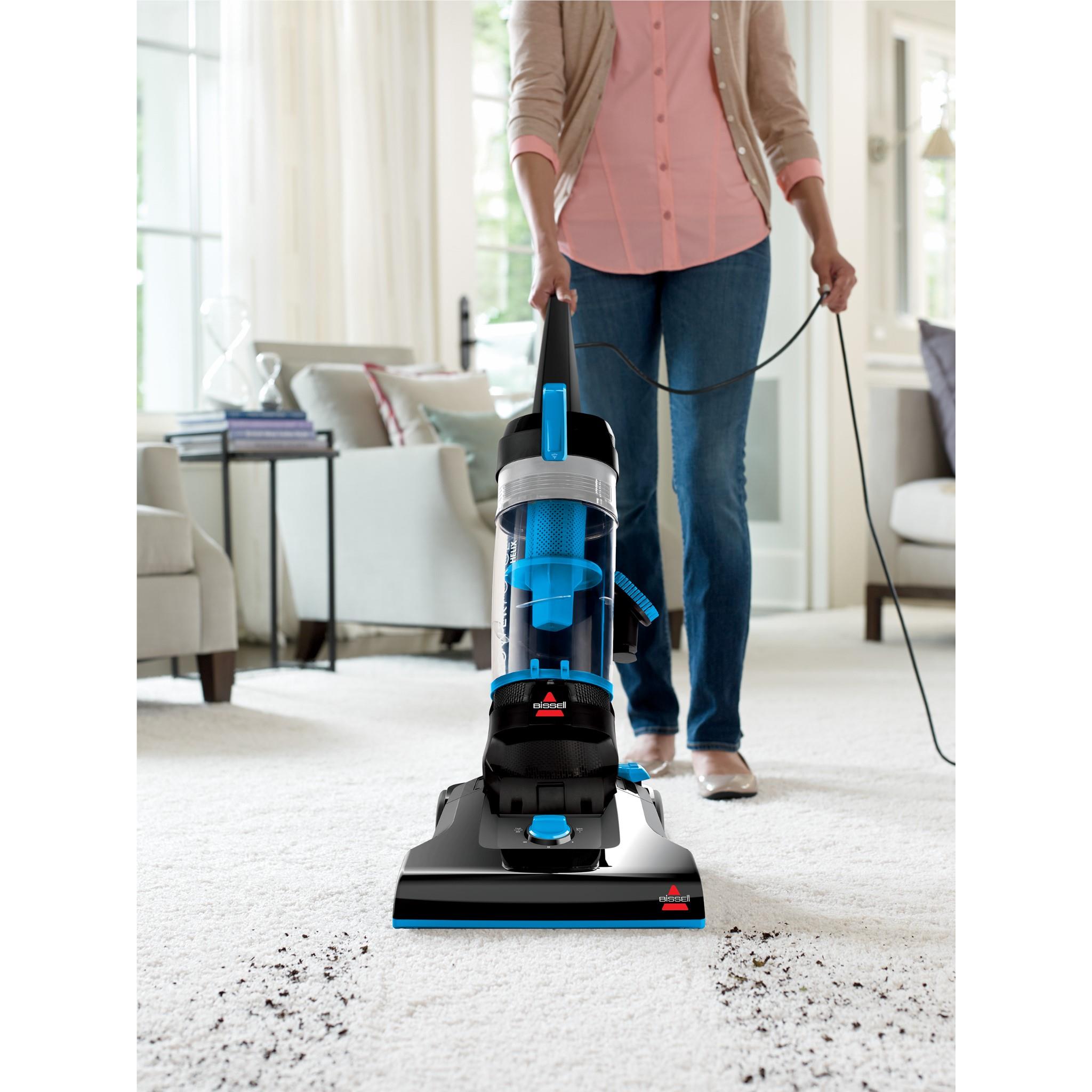 Bagless upright vacuum cleaner cleaning carpet with powered floor nozzle