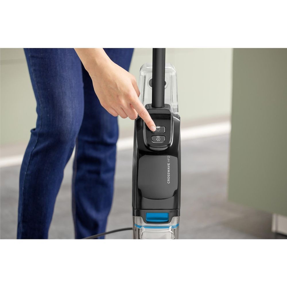 Upright wet and vacuum hard floor cleaner handle with blue power control, black body.