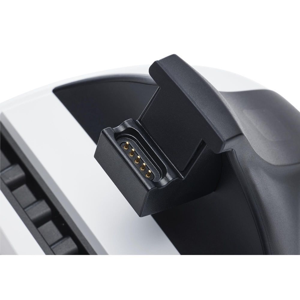 Close-up of charging station dock port with gold contacts inside the cradle