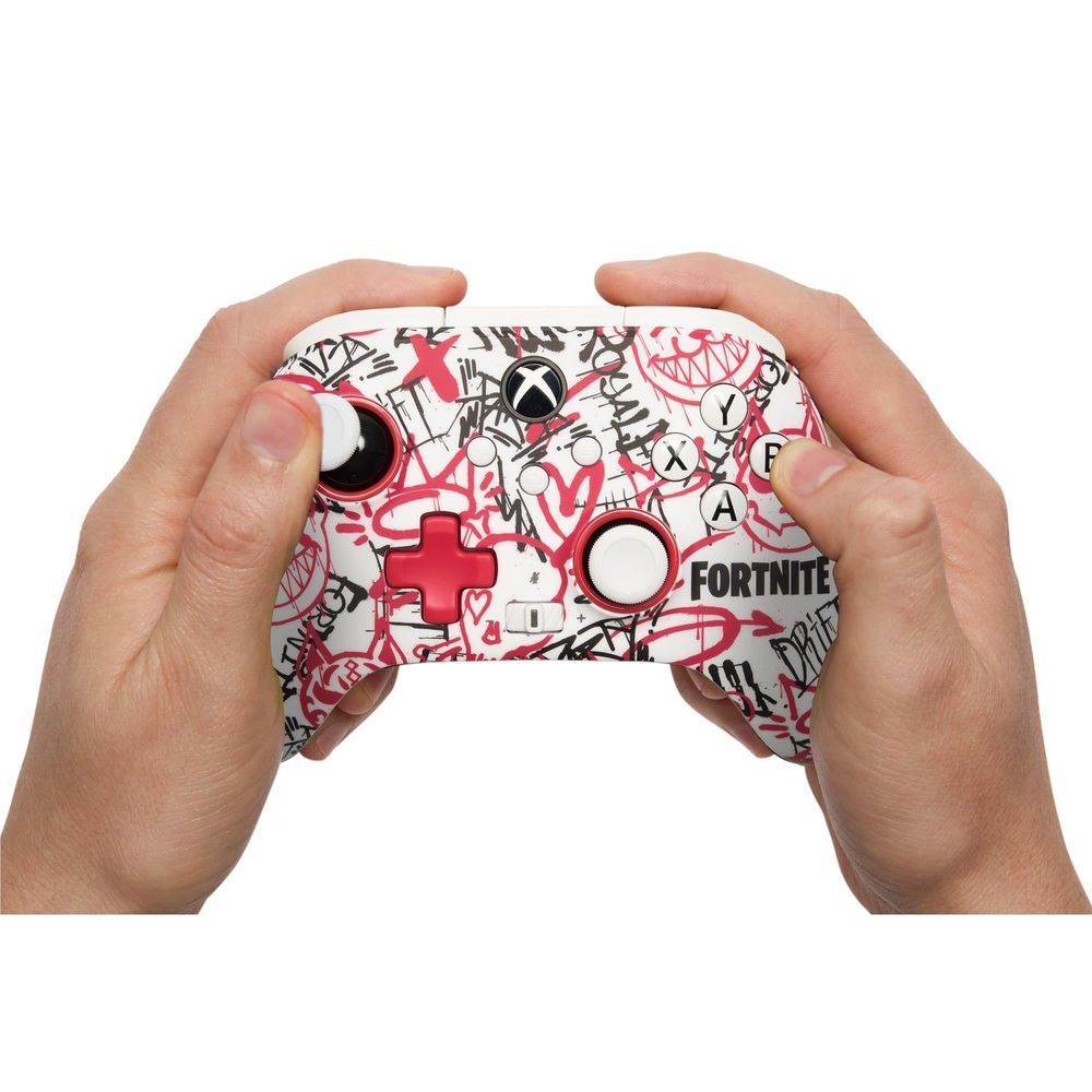 Hands holding Fortnite-themed Xbox wireless controller with graffiti red/white design