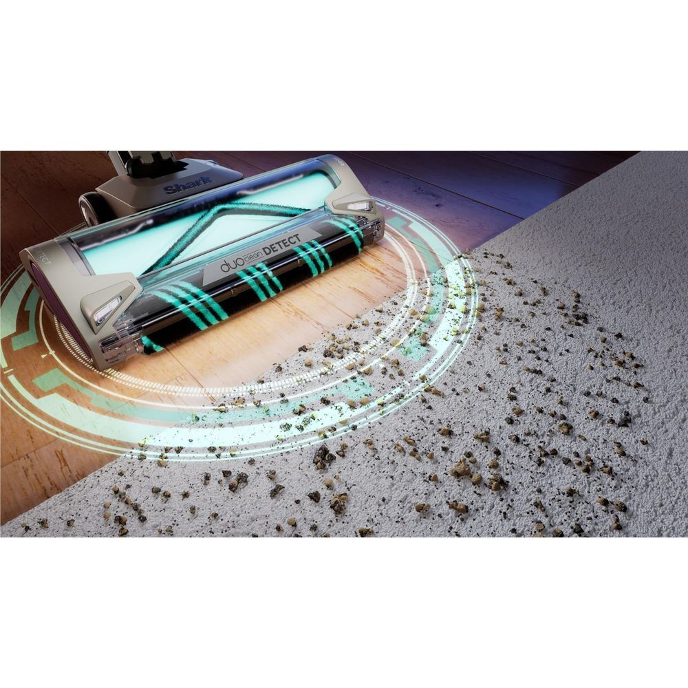 Cordless stick vacuum cleaning a carpet with visible dirt and illuminated circular track