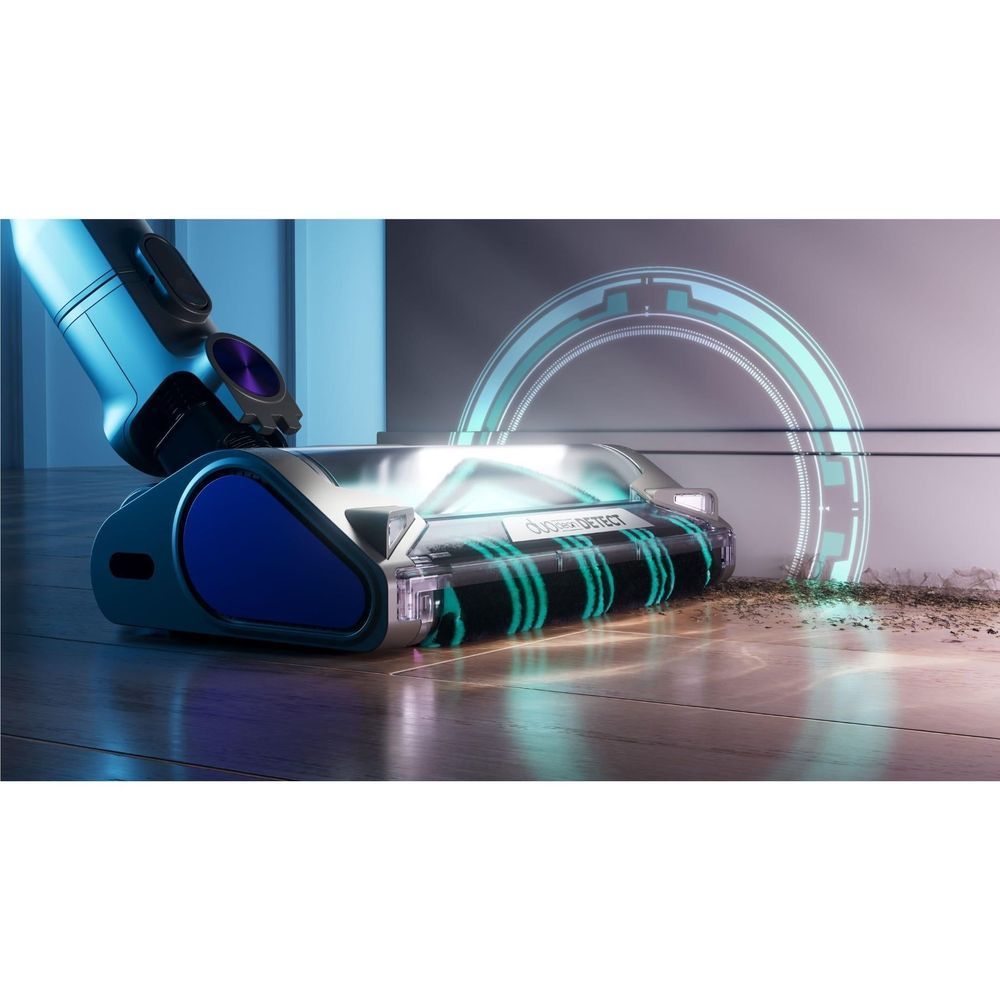 Cordless stick vacuum on hard floors with rotating brush head and visible debris pickup