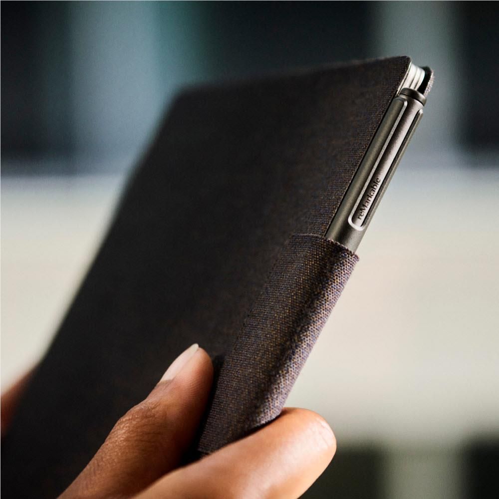 Hands holding basalt folio case with marker pen tucked beside cover