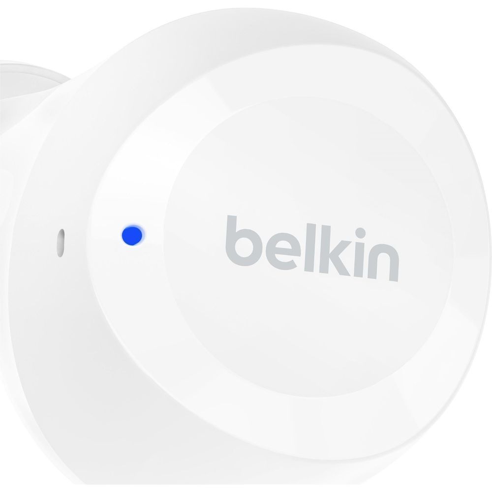 White Belkin earbud with blue LED dot and logo on charging surface
