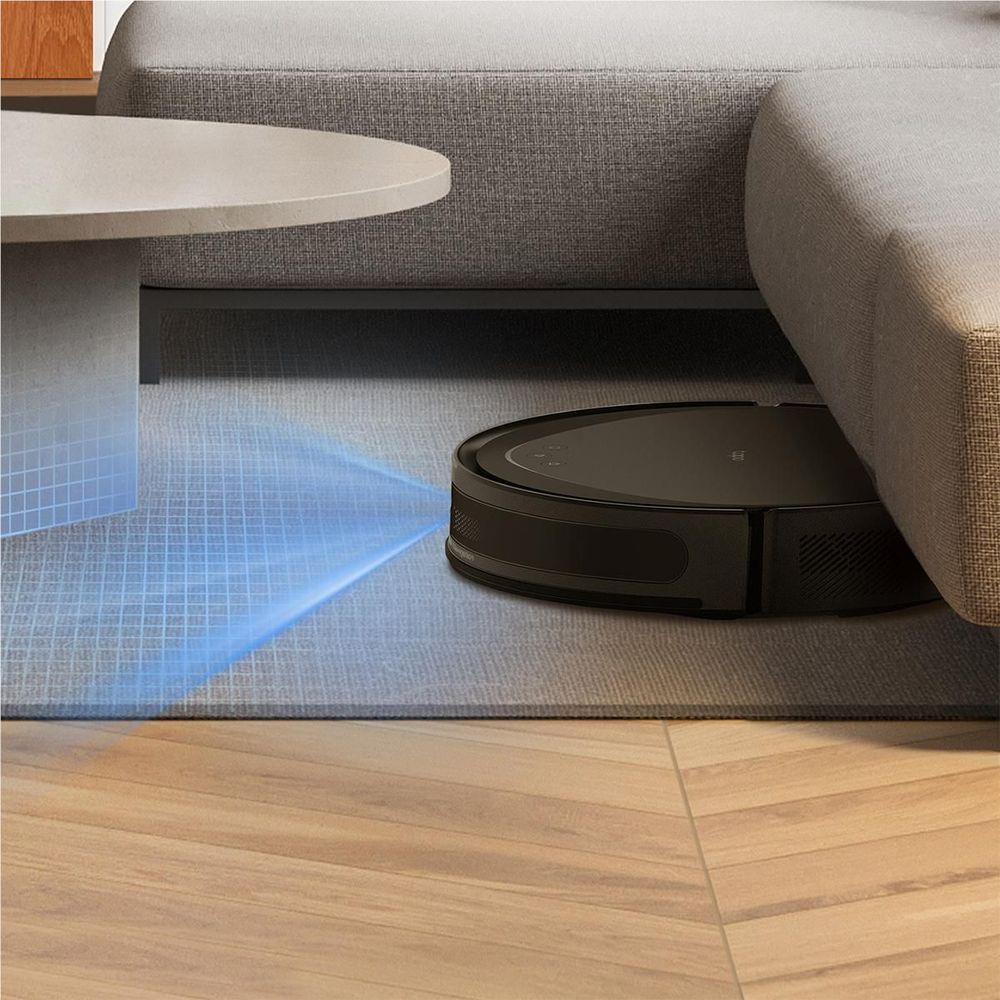 Robot vacuum and mop sweeping under a sofa with blue laser guidance