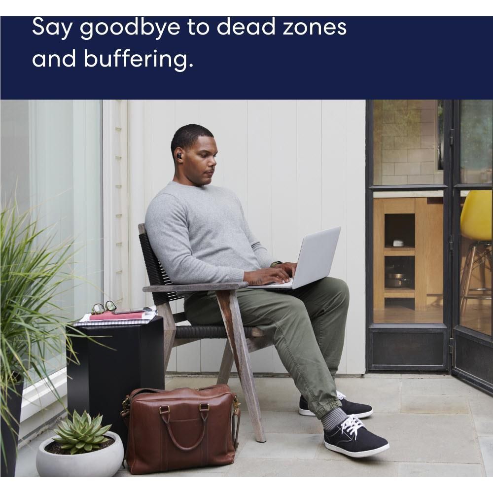 Mesh Wi-Fi router system for eliminating dead zones shown with a laptop user