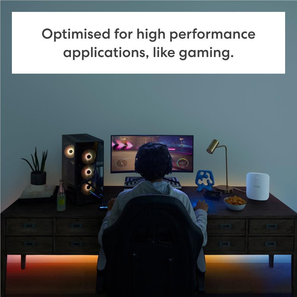 eero Max 7 mesh Wi-Fi 7 router on desk among gaming accessories