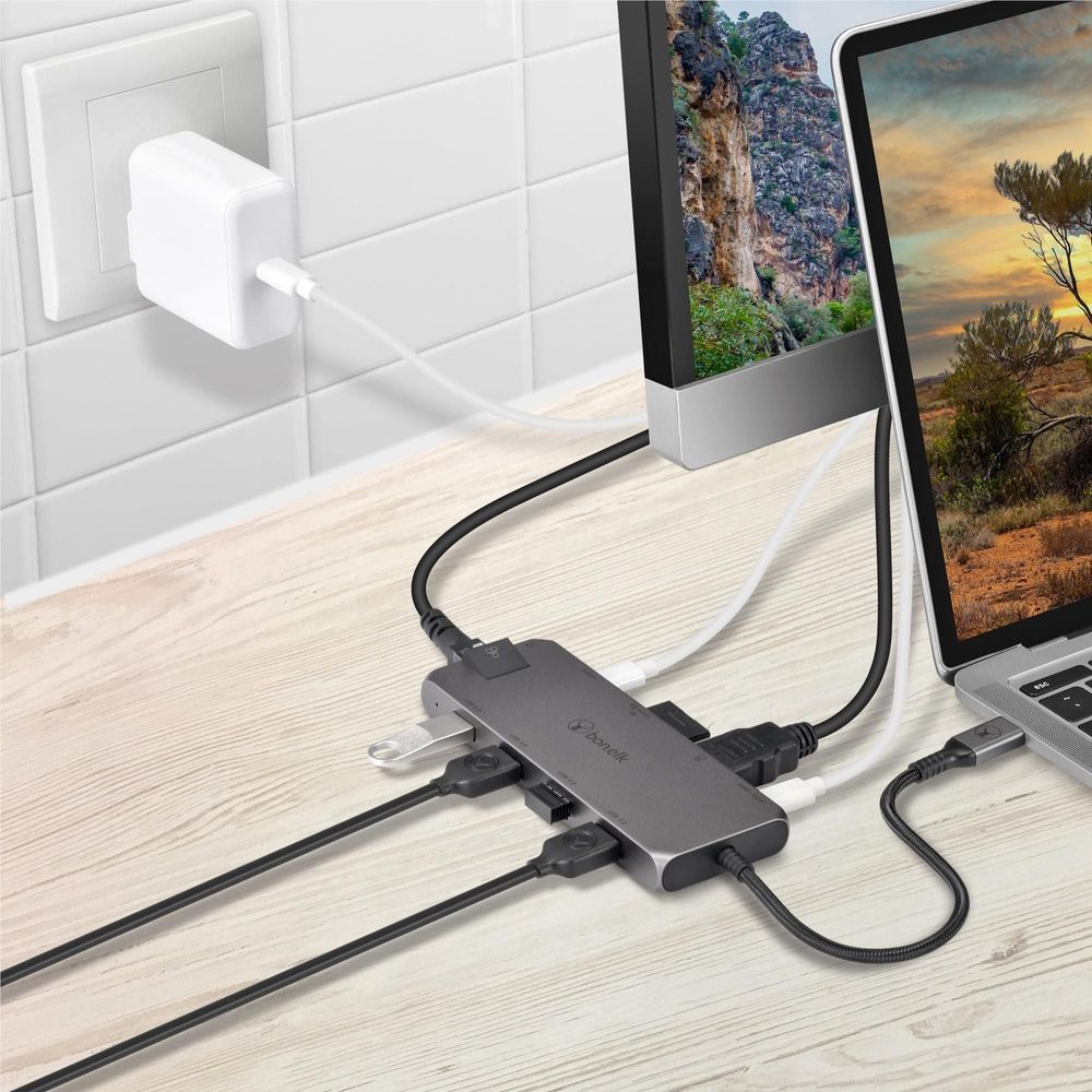 Space gray USB-C hub connected to devices and wall outlet via cables
