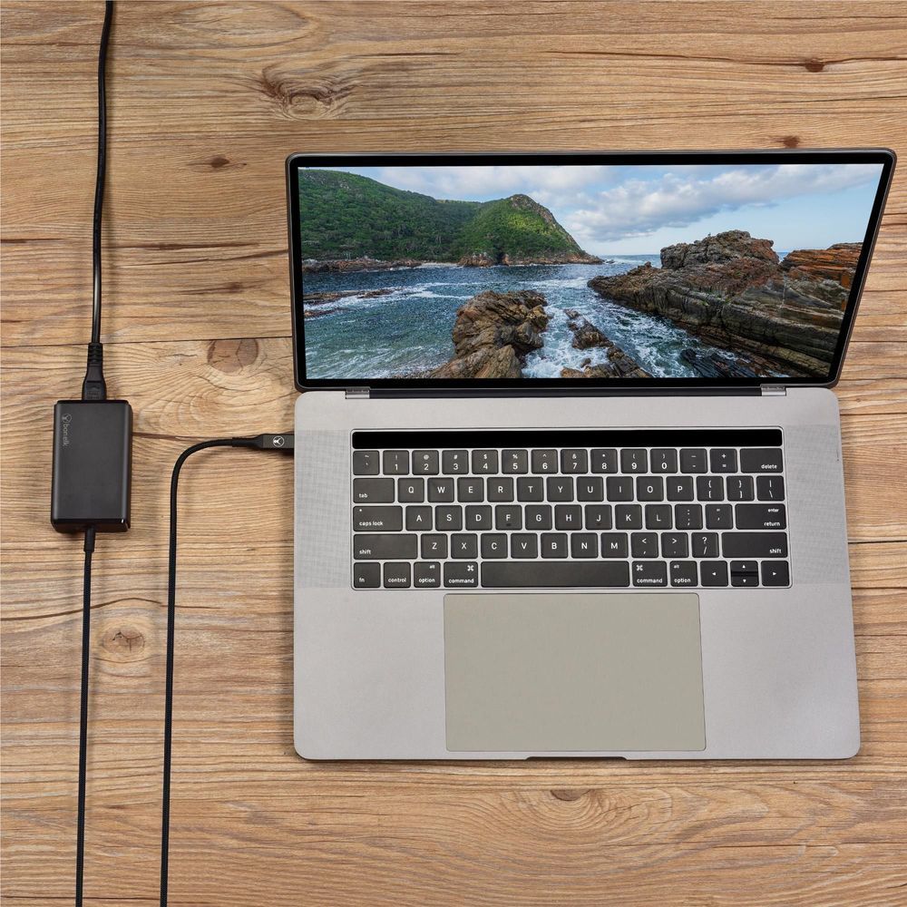 Black PD charger connected to laptop via USB-C cable, compact power brick