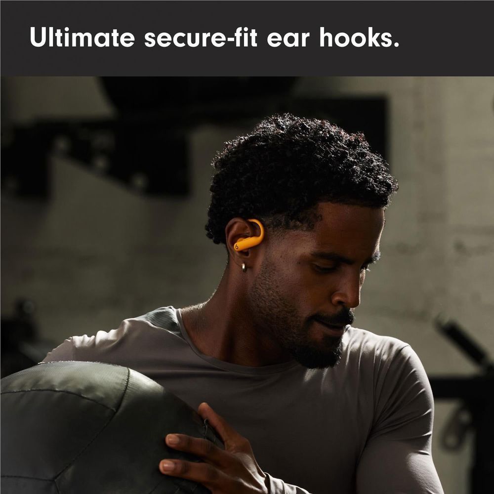 Orange secure-fit earbuds worn in ear with ear hook