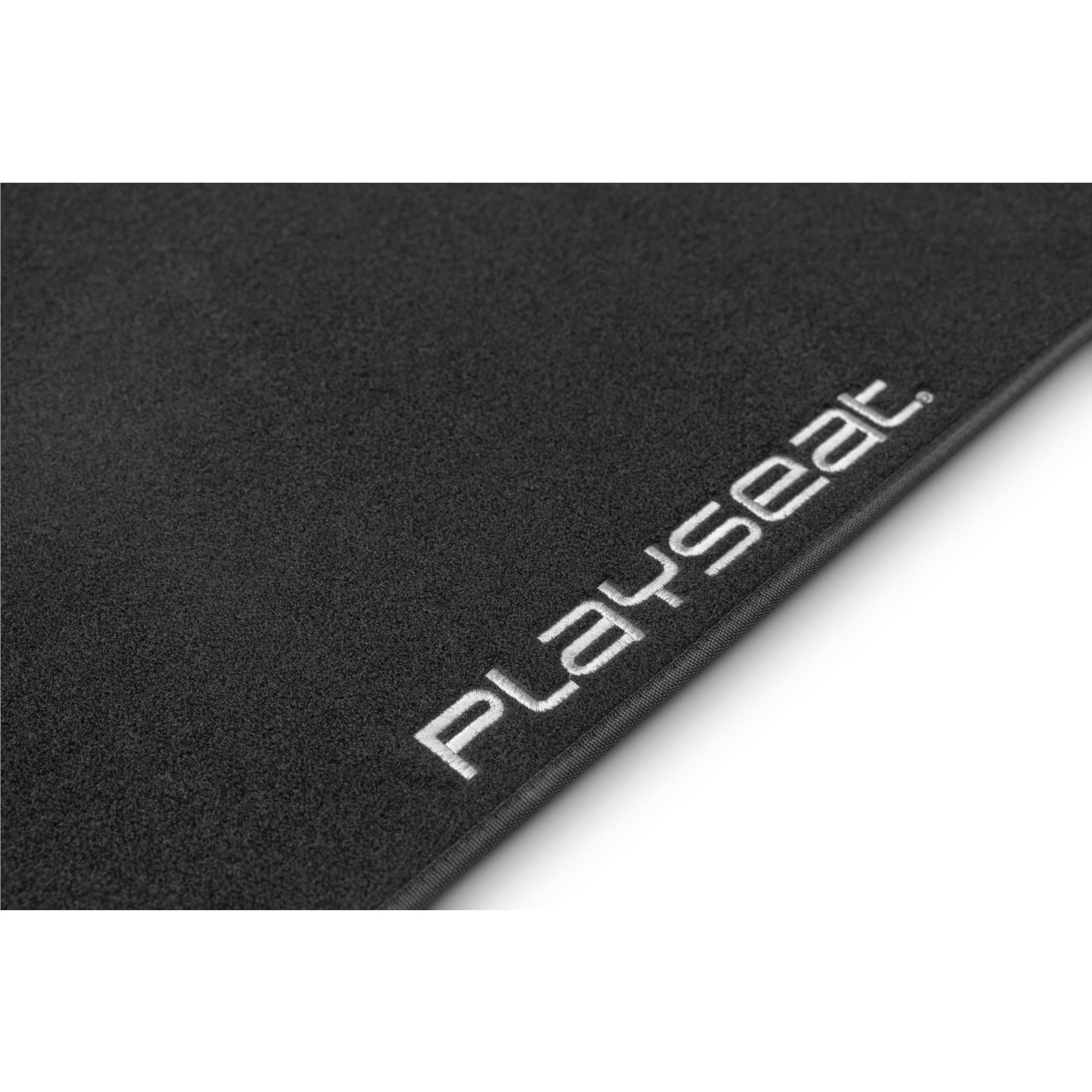 Anti-slip floor mat close-up with Playseat logo on dark charcoal surface