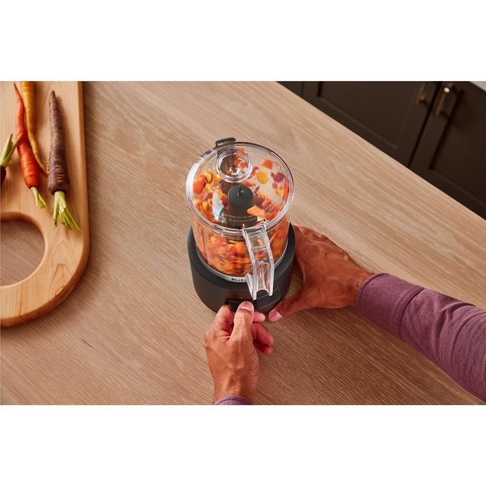 KitchenAid food chopper processing ingredients inside clear bowl