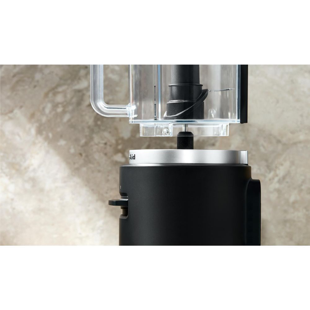 KitchenAid food chopper with clear lid and black motor housing on countertop