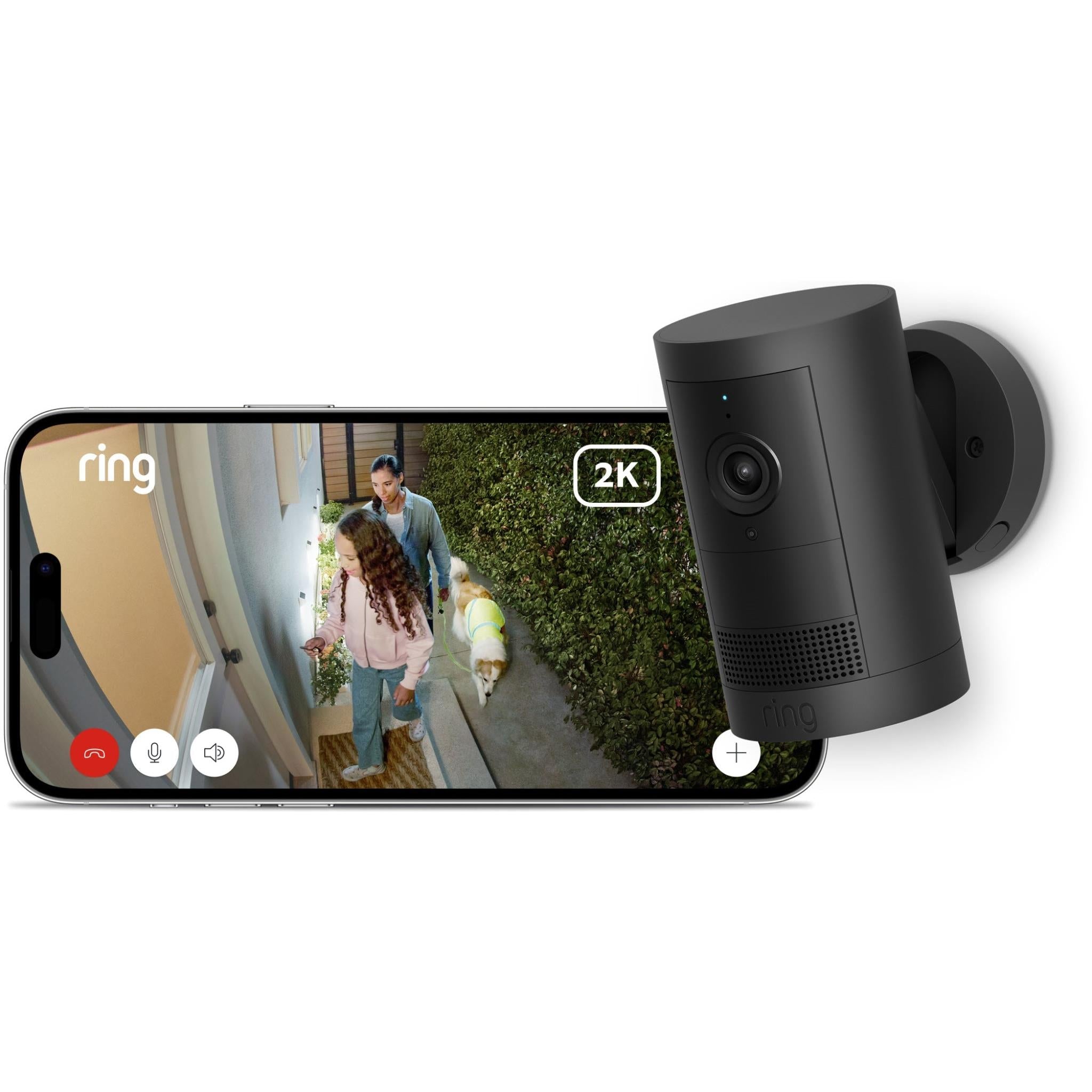 Black outdoor battery security camera next to smartphone showing live video