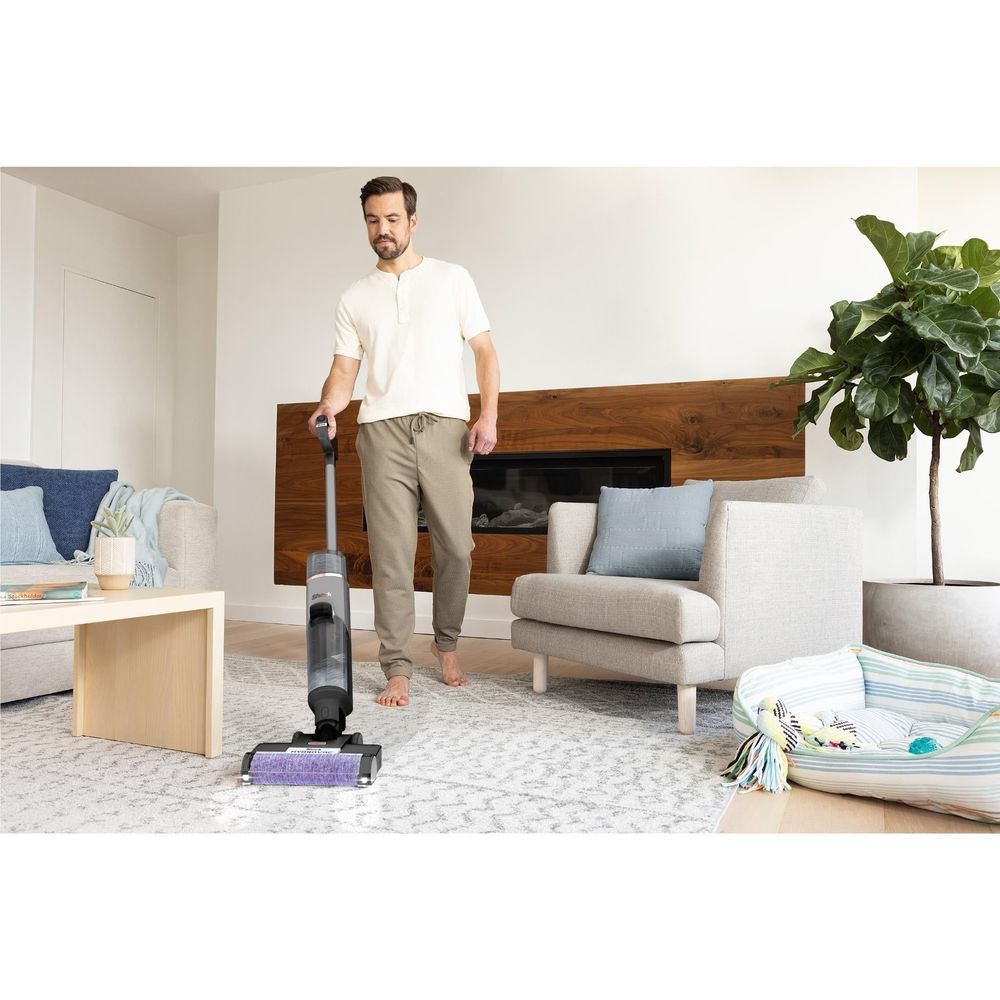 Cordless wet/dry vacuum standing on carpet with purple floor nozzle