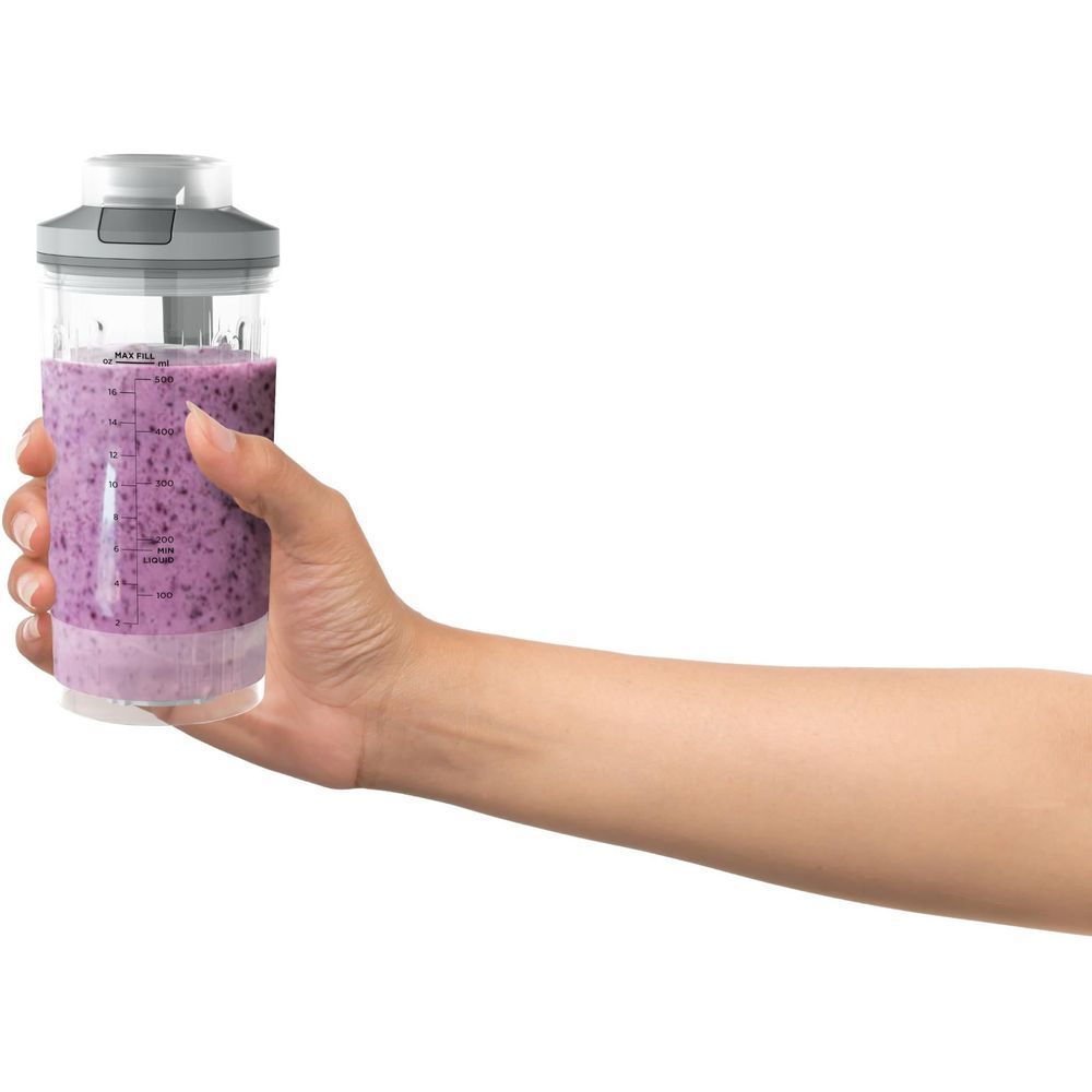 Cordless portable blender in use with hand holding jar filled with purple smoothie
