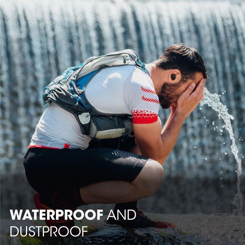 Runner crouching outdoors wearing white wireless earbuds with water splashes
