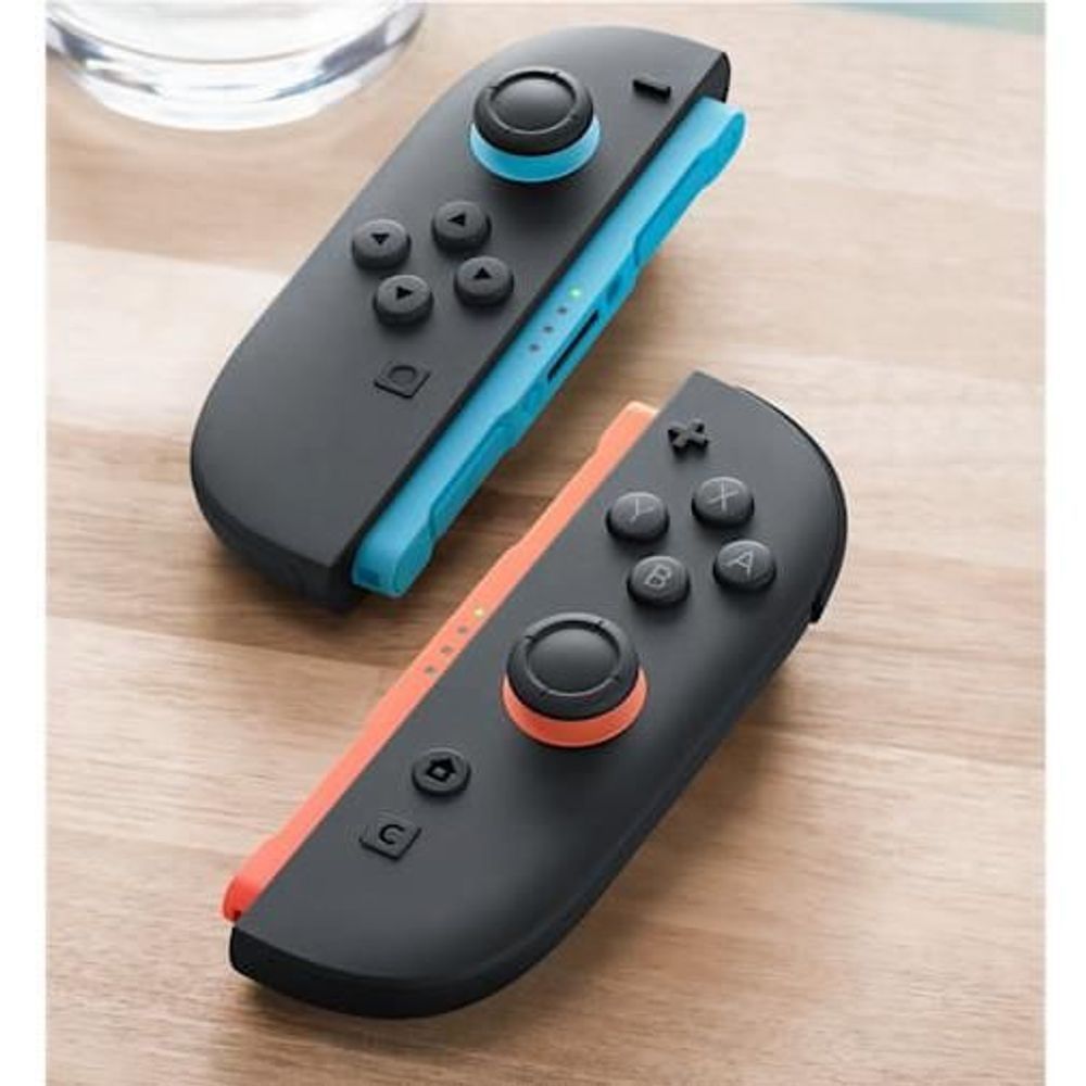 Nintendo Switch 2 Joy-Con pair with wrist straps, black shells with light blue and light red