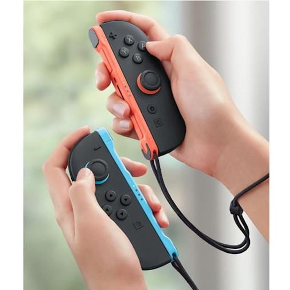 Nintendo Switch 2 Joy-Con pair held in hands, black with light blue and light red accents