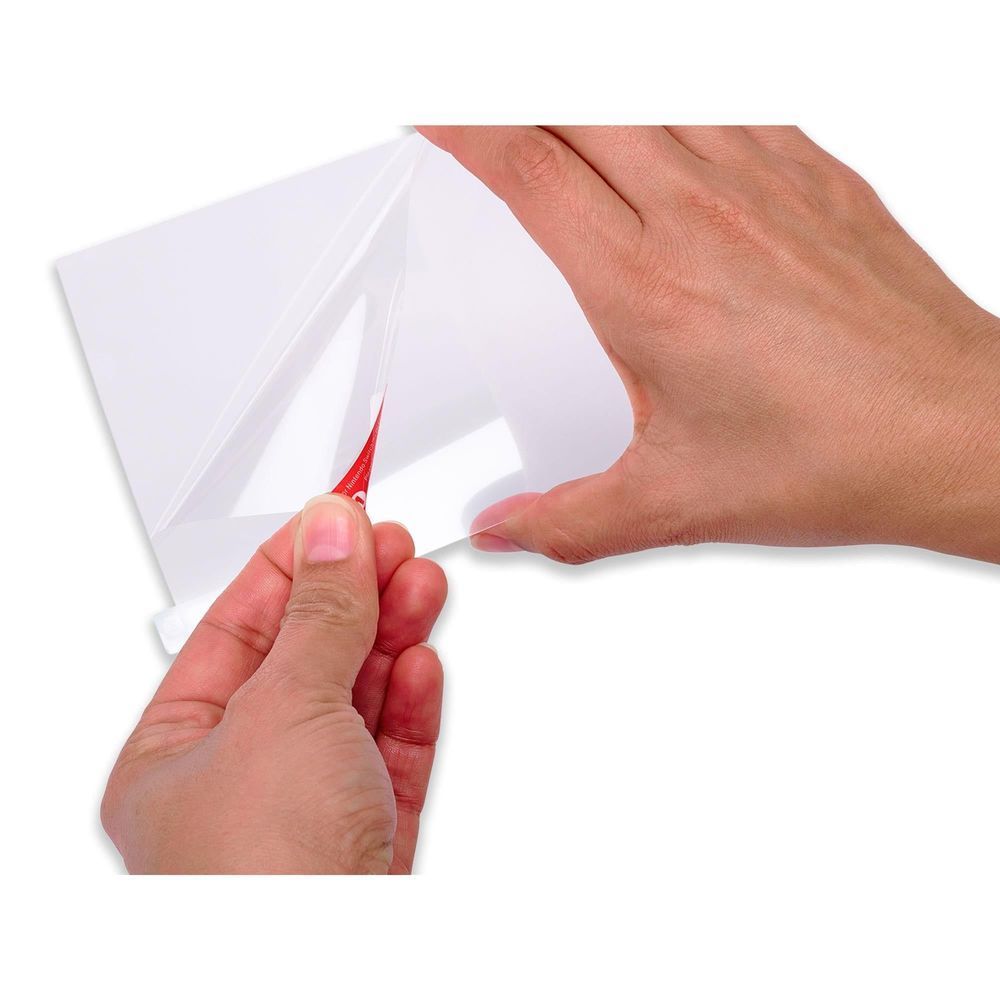 Screen protector application: hands align a clear film for Nintendo Switch 2