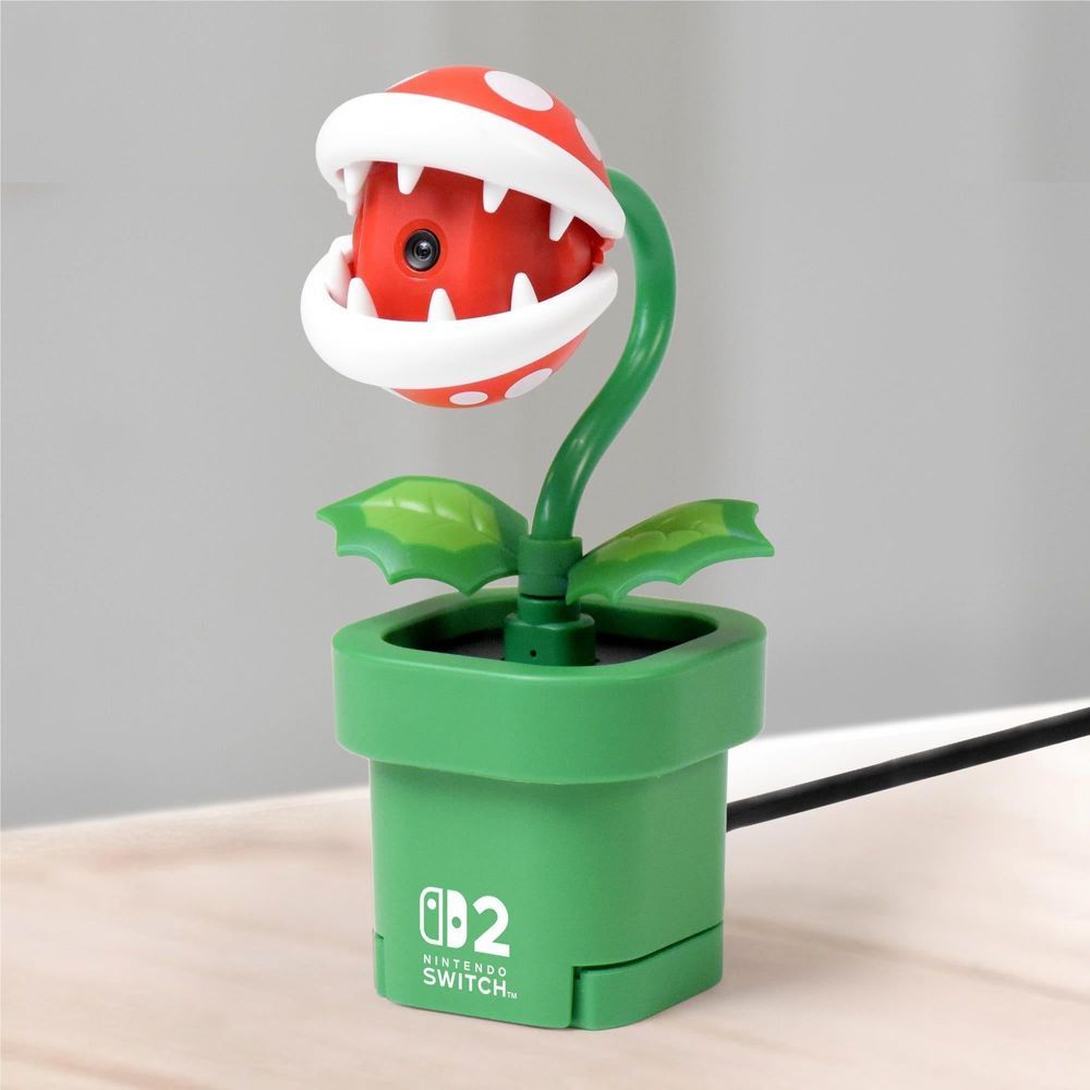 Piranha plant camera accessory standing with red white head, green leaves, and green pot