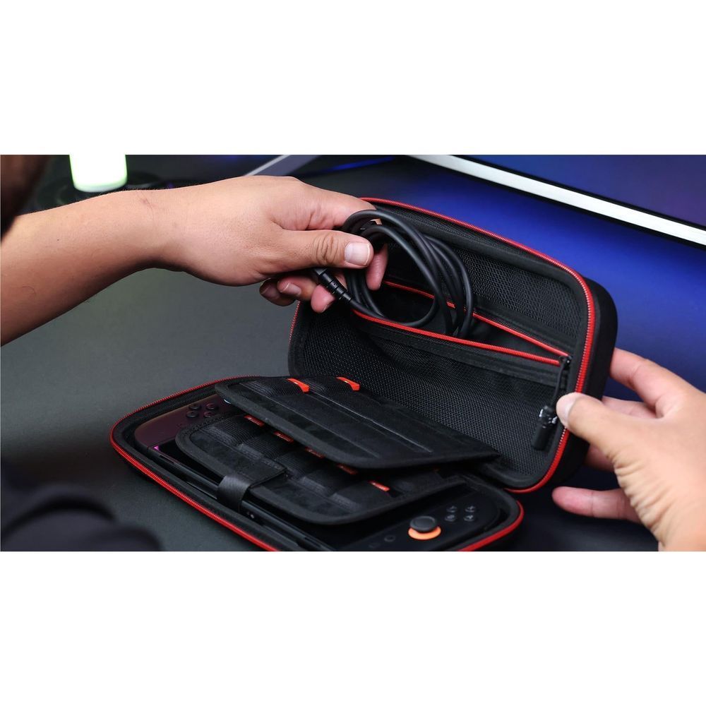 Hands open black carry case showing console insert area and controller storage