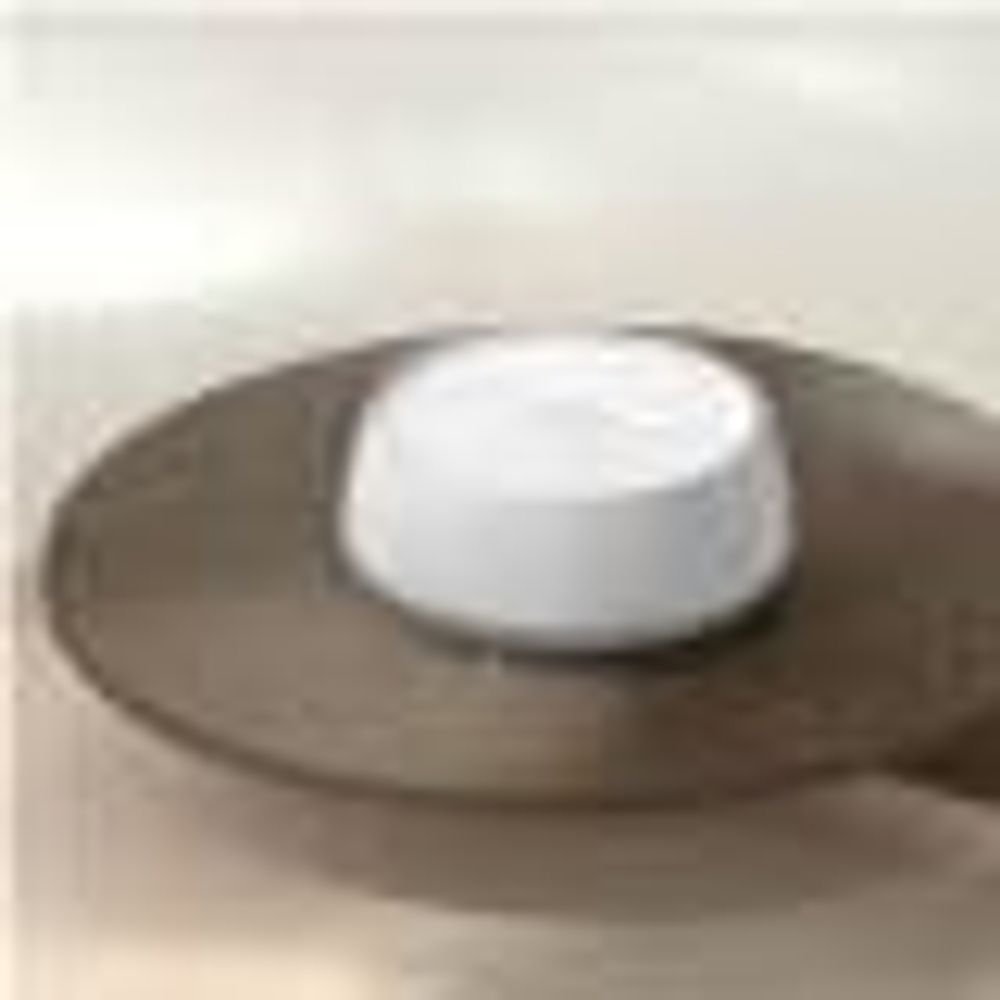 White TP-Link Deco mesh Wi-Fi router node viewed from above