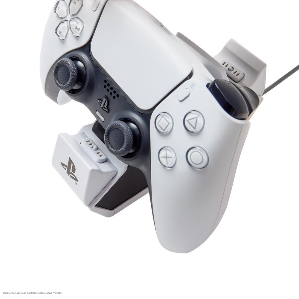 Close-up of two controllers docked on a white twin charging station