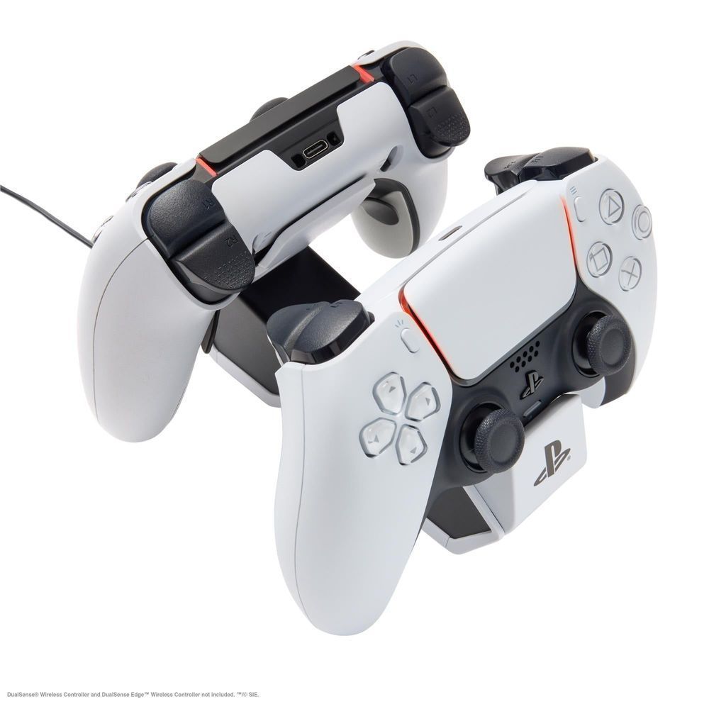 White twin charging station holding two PS5 controllers side by side