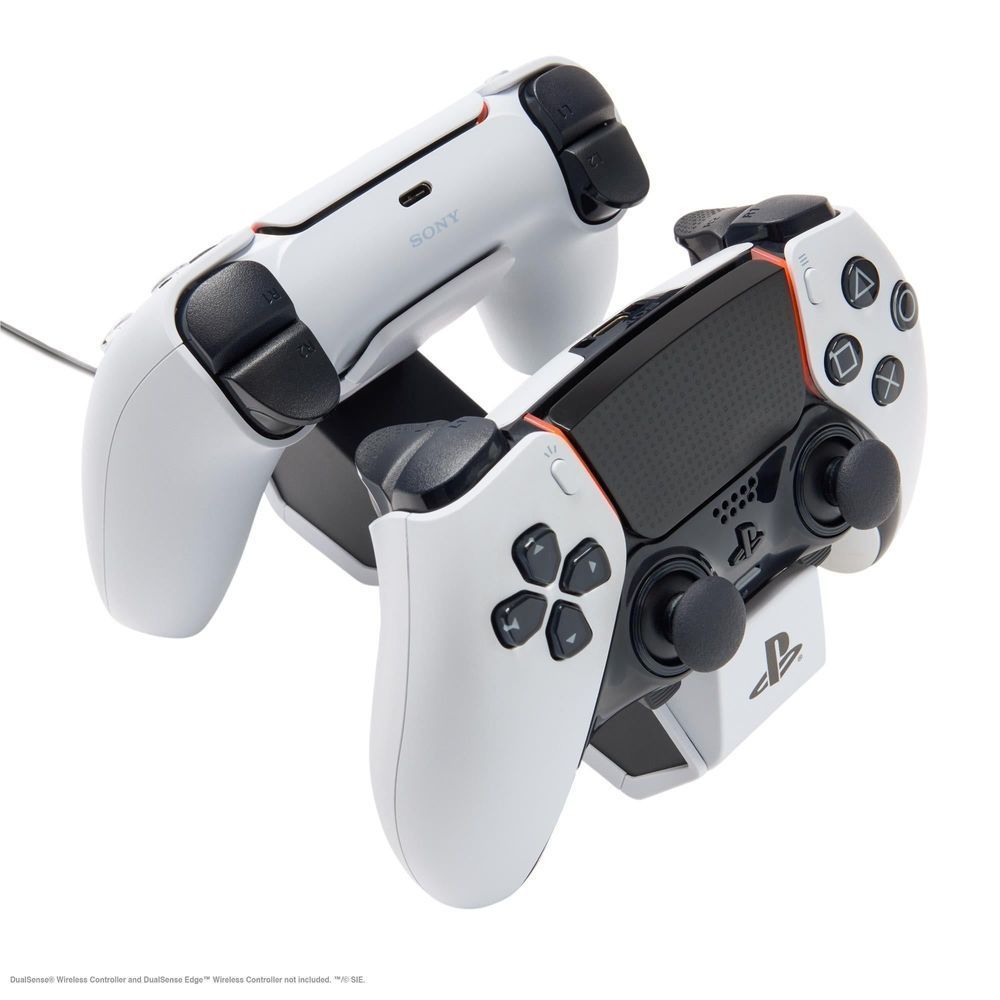 White twin charging station with two PS5 controllers docked and cables connected