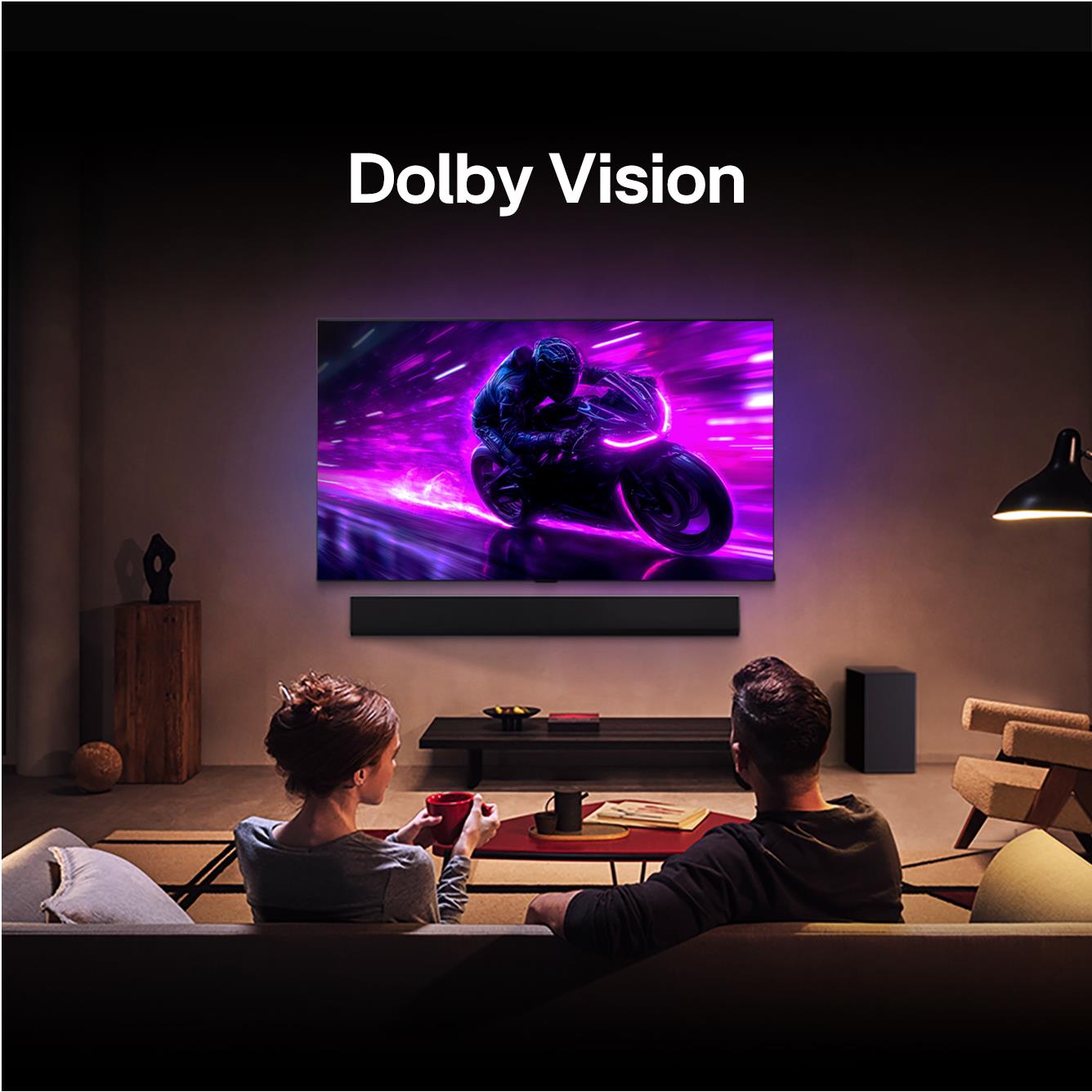Living room scene with wall-mounted 4K smart TV showing vivid action video