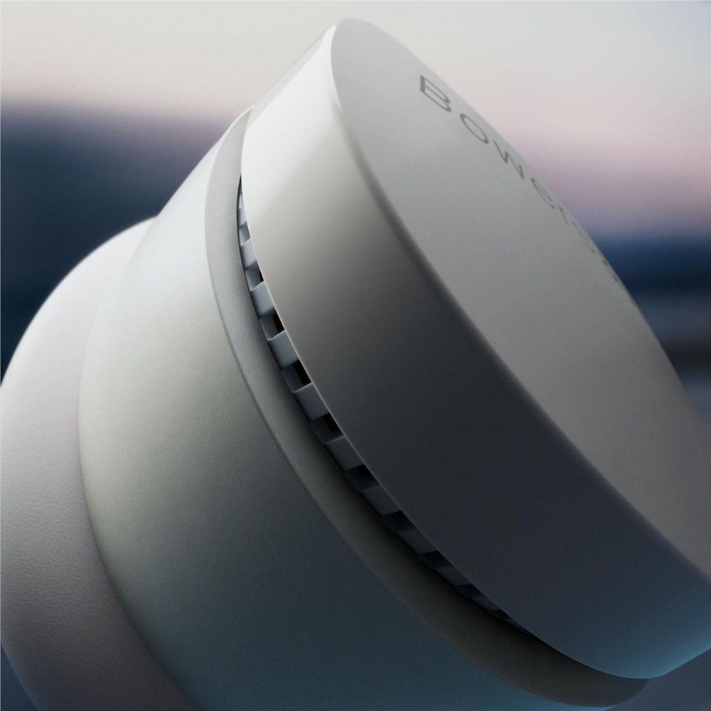 Cloud grey wireless earbuds close-up showing speaker grille and stem