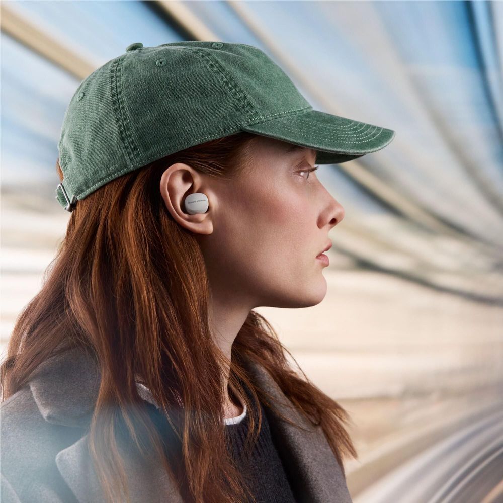 Cloud grey wireless earbuds in ear, side view, silicone tip visible