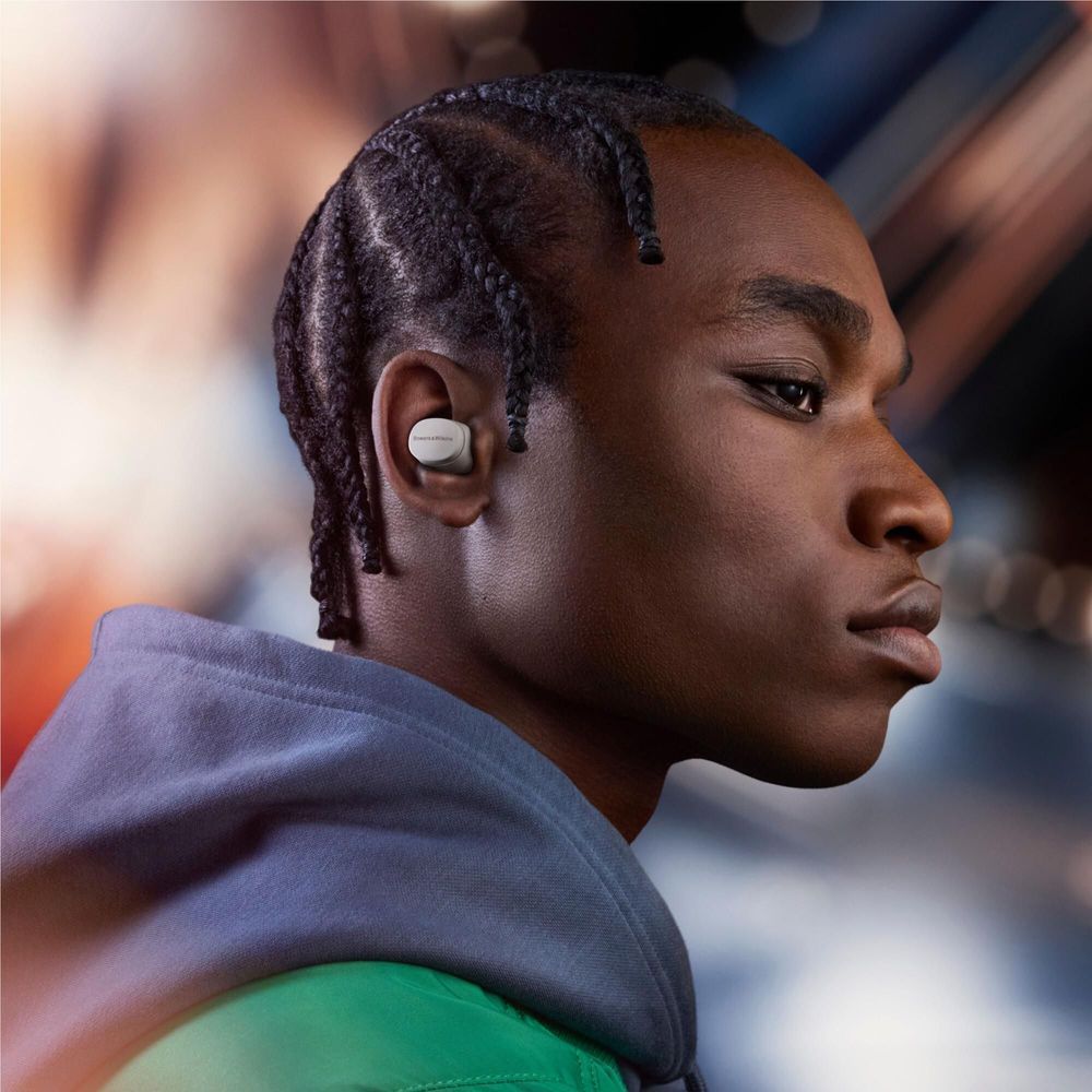 Cloud grey wireless earbuds in ear, side view, silicone tip visible