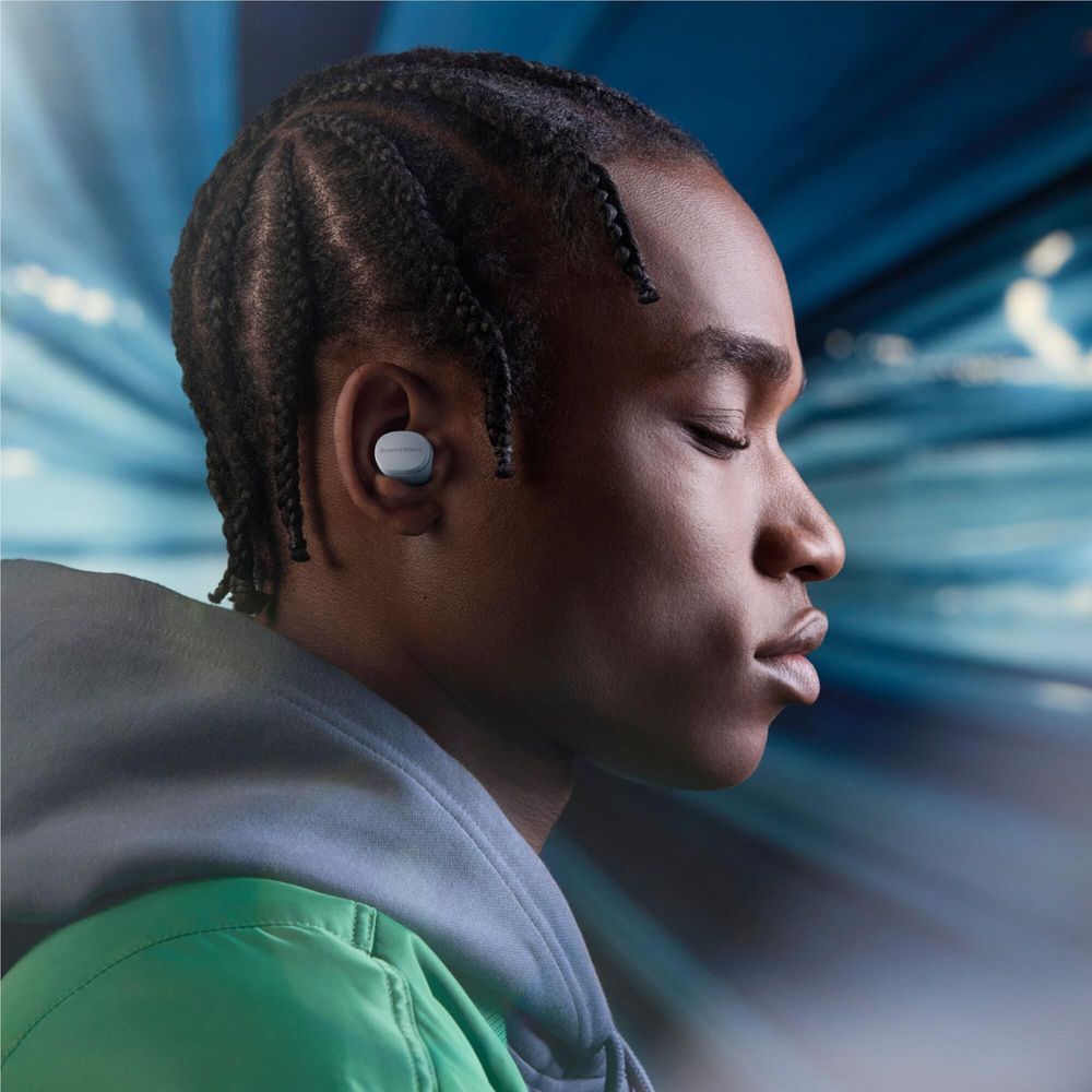 Wireless earbuds in ear on a person with braided hair