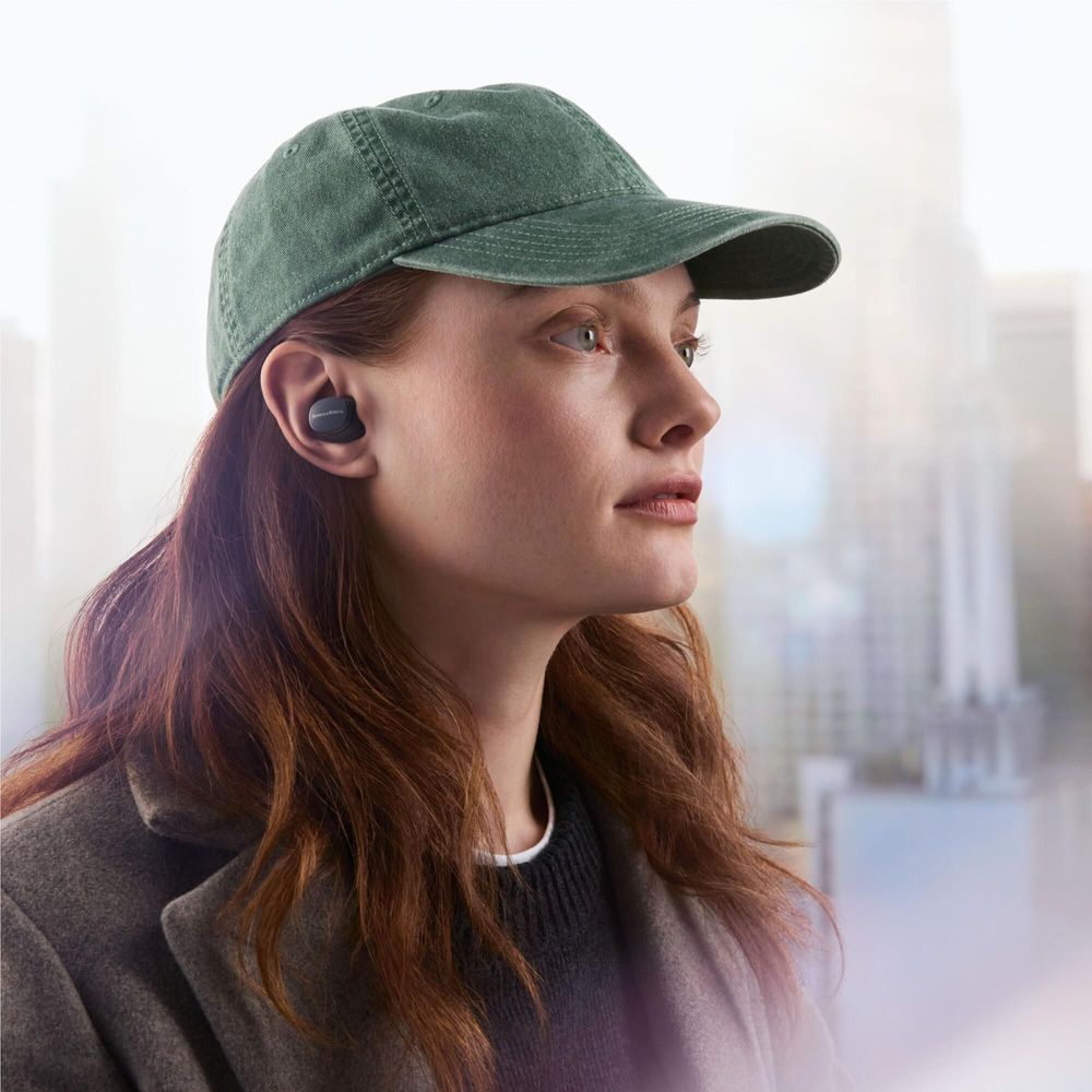 Storm grey PI6 ANC TWS earbud in ear, with green cap