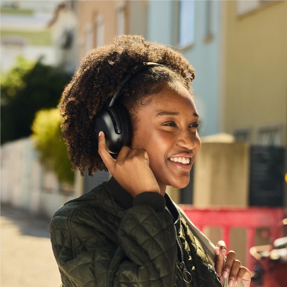 Black over-ear wireless noise-cancelling headphones worn over ears