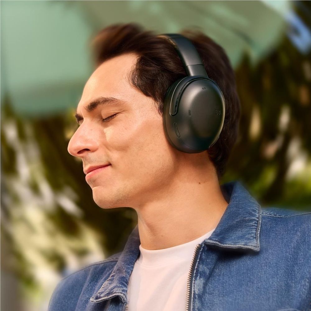 Black over-ear wireless noise-cancelling headphones on head, side view