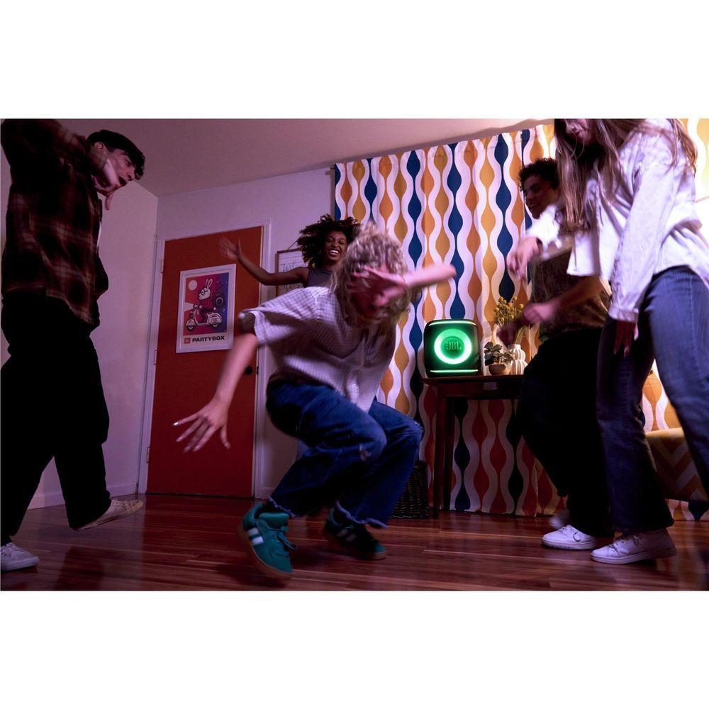 JBL PartyBox Encore Essential 2 portable party speaker with green light glow during party