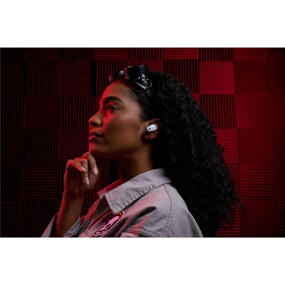 White wireless earbuds in ear, side profile with dark hair and earhook
