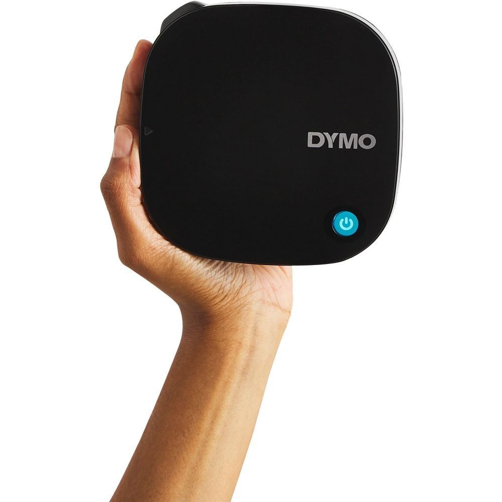 Black DYMO LetraTag label maker held in a hand with blue power button