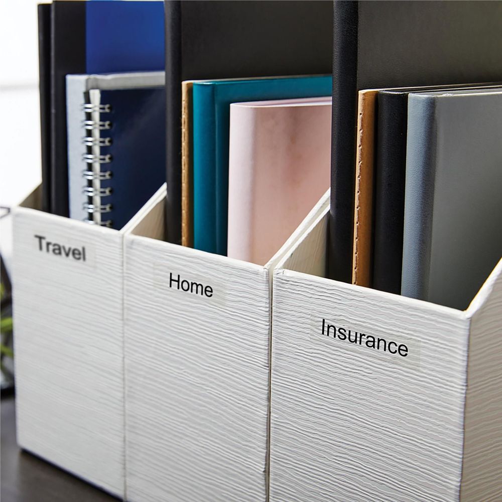 Organizer bins with white labels reading Travel, Home, and Insurance