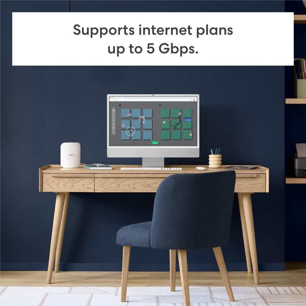 eero Pro 7 router on a desk next to a computer monitor